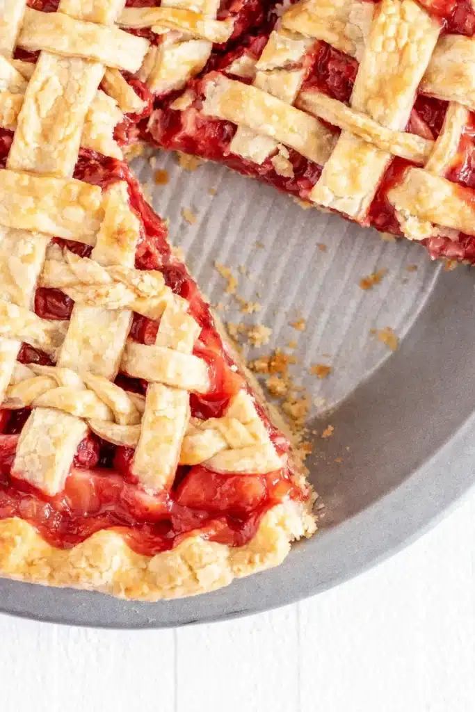 Strawberry Rhubarb Pie Recipe That Feels Amazing 8 strawberry rhubarb pie with flaky lattice crust and slice removed