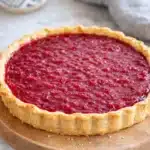 Sweet rhubarb custard tart with glossy rhubarb topping and golden shortcrust pastry