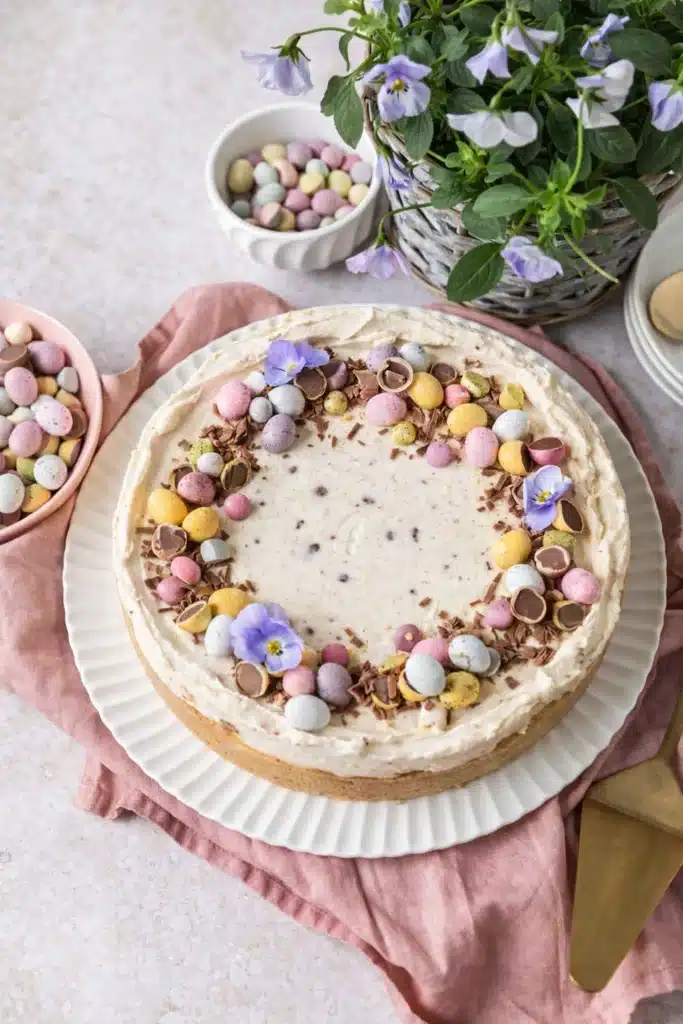 Easter No-Bake Mini Egg Cheesecake decorated with pastel chocolate eggs and chocolate curls
