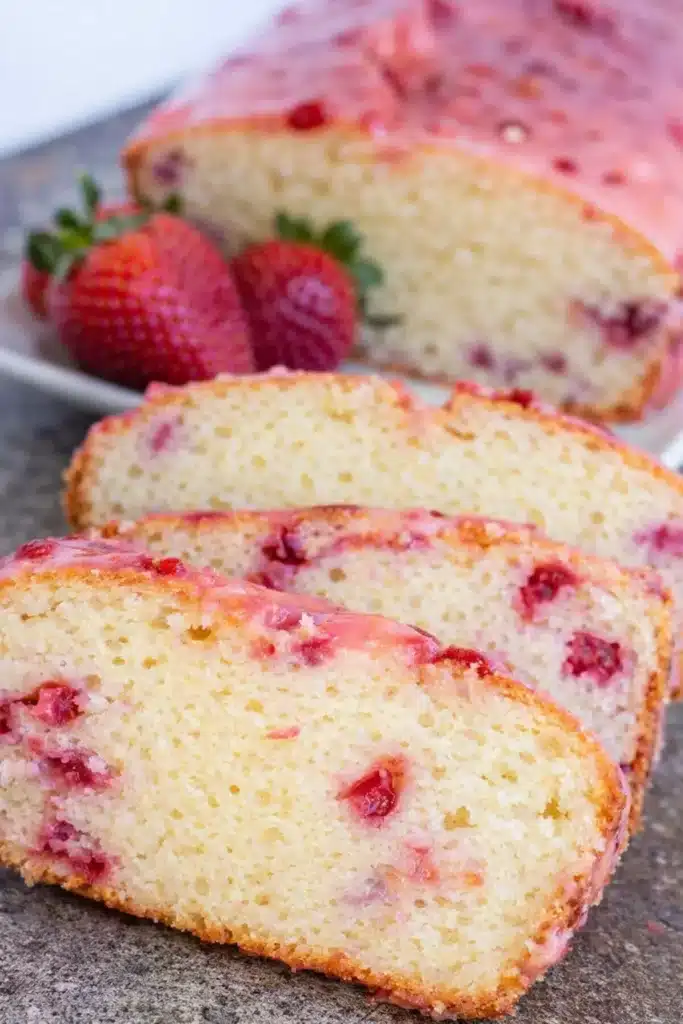 Easy strawberry pound cake slices with pink glaze and fresh strawberries