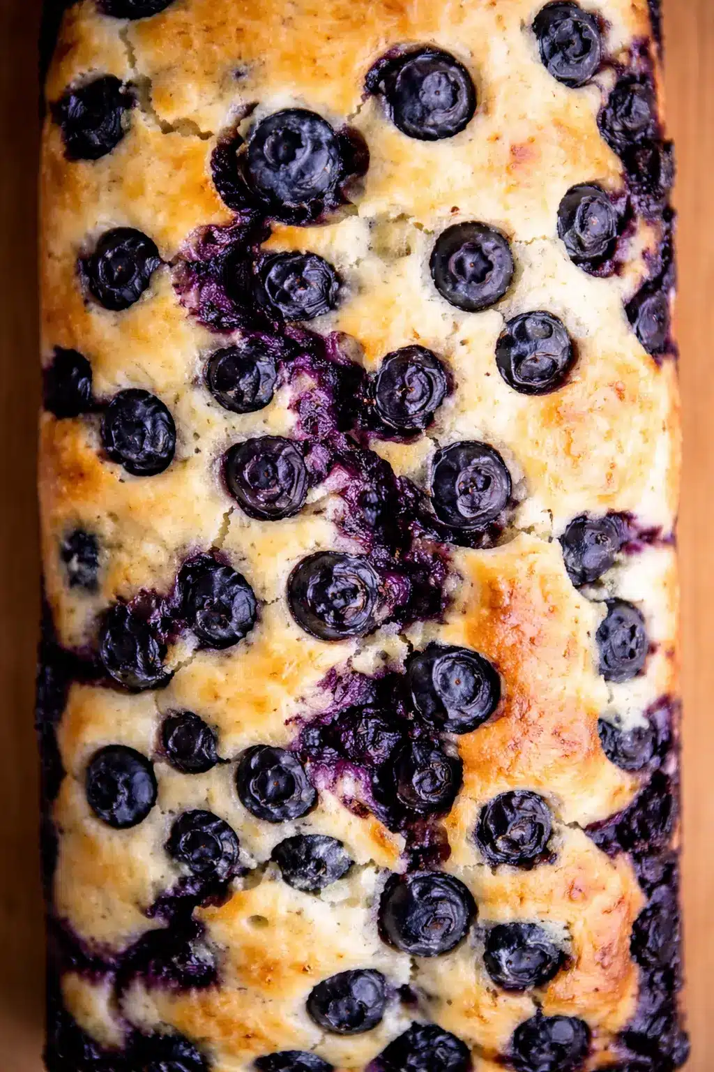 home 7 Close-up of lemon blueberry bread with juicy baked blueberries and golden moist loaf