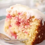 Rhubarb Cake with Cake Mix | Amazing Easy Dessert 5 Rhubarb cake slice with vanilla glaze on a plate, soft crumb and pink rhubarb pieces