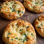 Easy spinach cottage cheese flagels with golden crust and visible spinach baked on a rustic surface ..