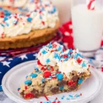 4th of July cookie cake slice with frosting and festive red white and blue sprinkles