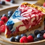 4th of July swirl pie slice with red and blue berry swirls and graham cracker crust