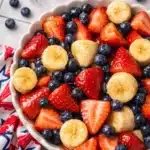 4th of July fruit salad with strawberries blueberries and bananas in a ceramic bowl