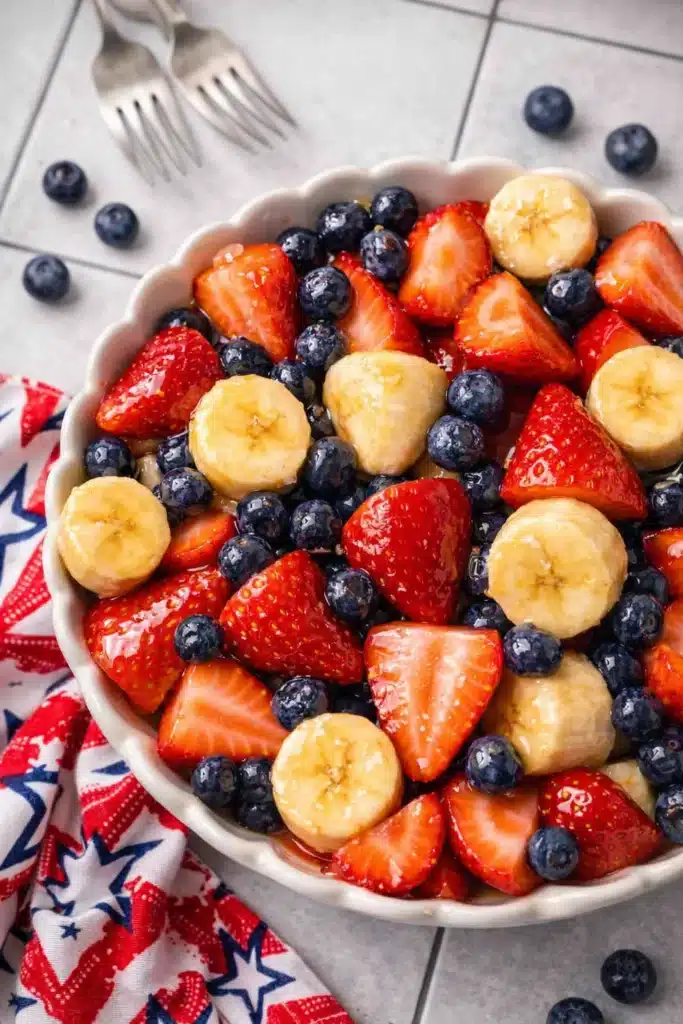 4th of July fruit salad with strawberries blueberries and bananas in a ceramic bowl