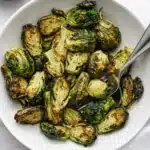 Crispy air fryer Brussels sprouts in a bowl with golden edges and tender green centers