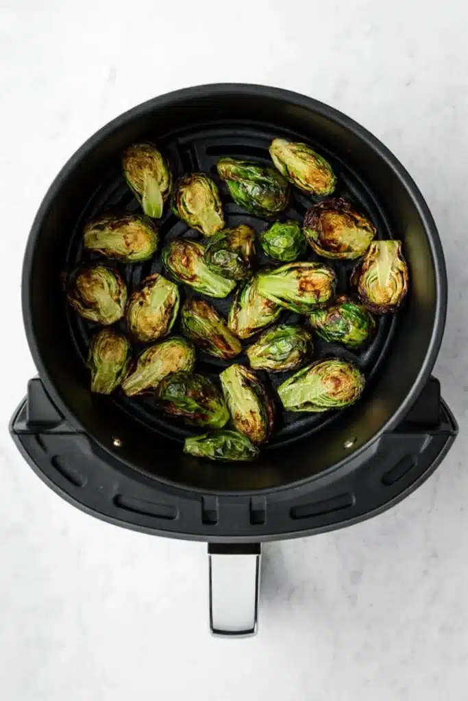 Air Fryer Brussels Sprouts cooking in basket with crispy edges and tender centers