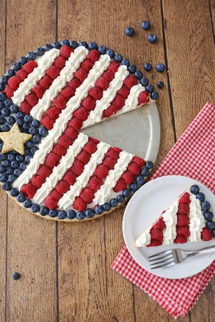 American flag fruit pizza with berries and cream on cookie crust for 4th of July dessert