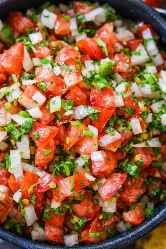 Authentic pico de gallo close up with tomatoes onion cilantro and jalapeño