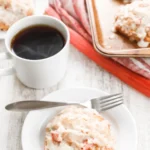 Baked rhubarb fritters with glaze served on plate with coffee