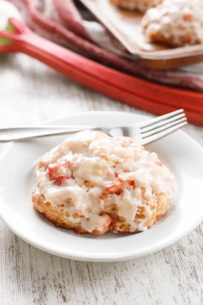Baked rhubarb fritters with glaze served on plate
