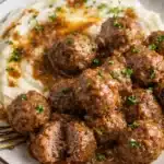 Beefy Onion Crockpot Meatballs Recipe Easy Comfort 7 Beefy onion crockpot meatballs with gravy over mashed potatoes