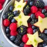 Berry fruit salad with blueberries, raspberries, blackberries, and apple stars in a bowl