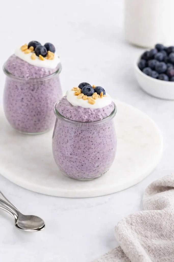 Blueberry Chia Pudding Easy Amazing Breakfast 6 Blueberry chia pudding with yogurt, blueberries, and granola in glass jars