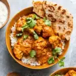 Butter Cauliflower Amazing Creamy Dinner Recipe 9 Butter cauliflower curry with rice, naan, and cilantro in a rustic bowl