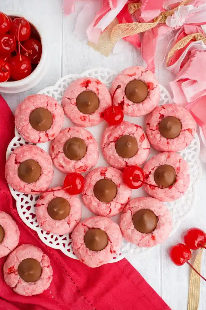 Cherry Blossom Cookies with chocolate centers and maraschino cherries on white plate