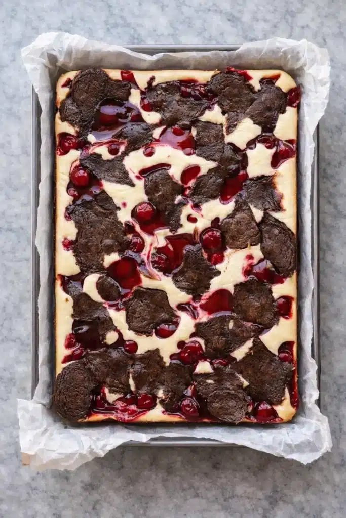 Cherry cheesecake brownies with fudgy chocolate, creamy cheesecake, and glossy cherry topping