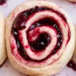 Cherry cinnamon rolls with glossy cherry filling in soft swirled dough