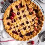Cherry pie with lattice crust and juicy cherry filling on cooling rack