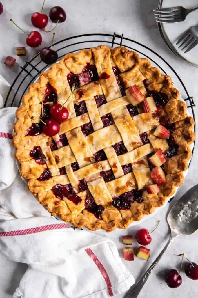 Cherry pie with lattice crust and juicy cherry filling on cooling rack