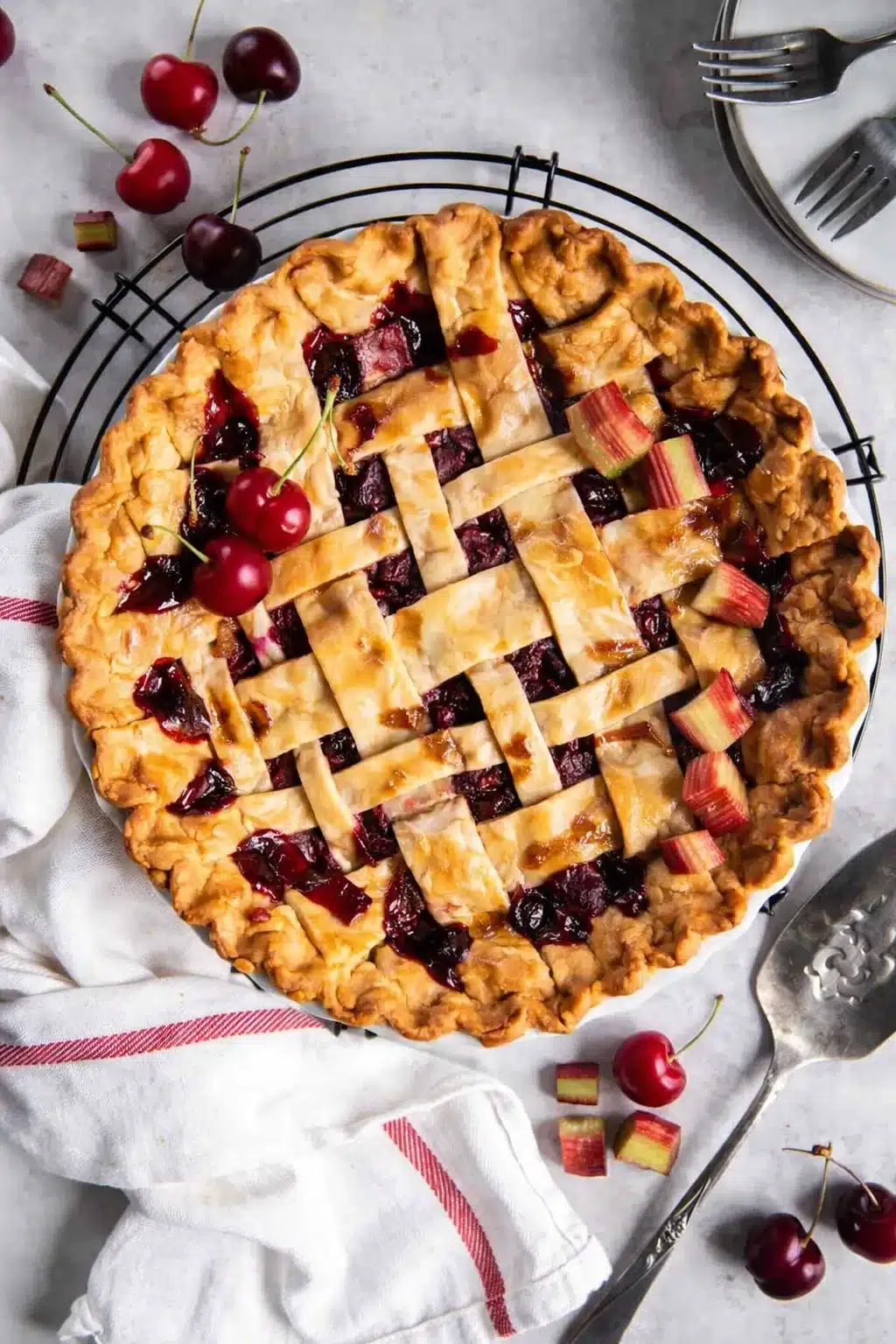 Cherry pie with lattice crust and juicy cherry filling on cooling rack