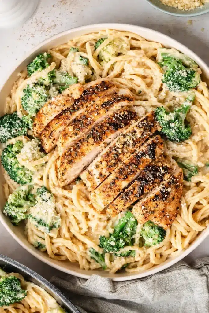 Chicken Alfredo pasta with grilled chicken and broccoli in creamy sauce