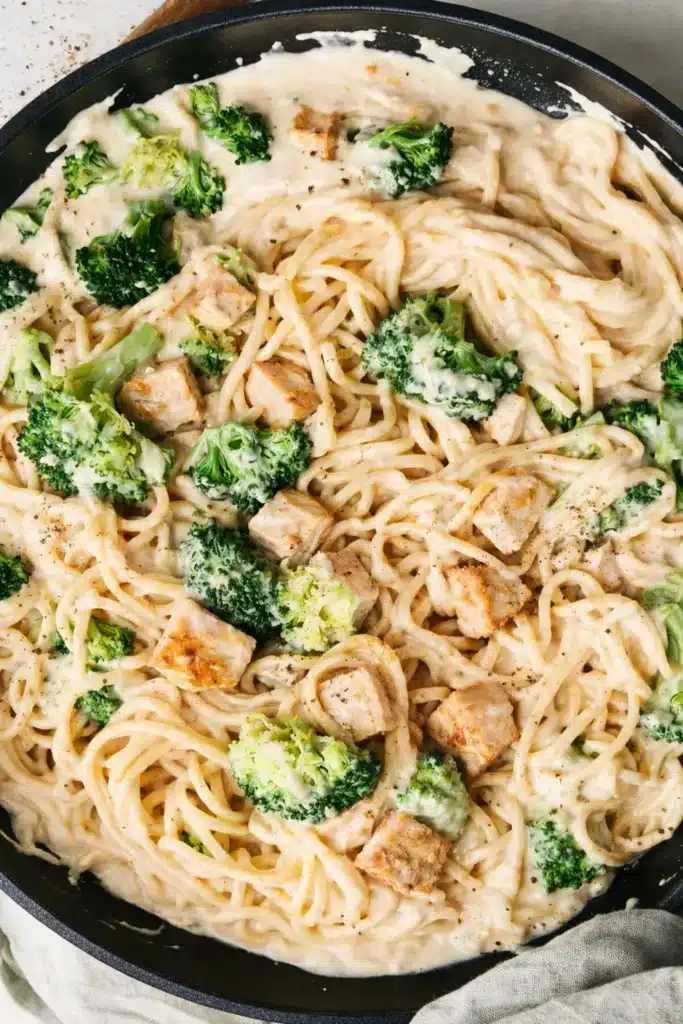 Chicken Alfredo Easy Creamy Dinner You Will Love 4 Chicken Alfredo pasta in skillet with broccoli and chicken pieces