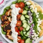 Chicken shawarma bowls with grilled chicken, fresh veggies, feta, and tzatziki sauce