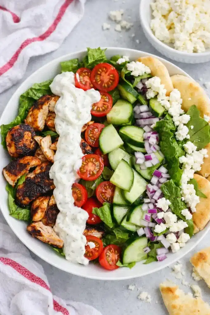 Chicken shawarma bowls with grilled chicken, fresh veggies, feta, and tzatziki sauce