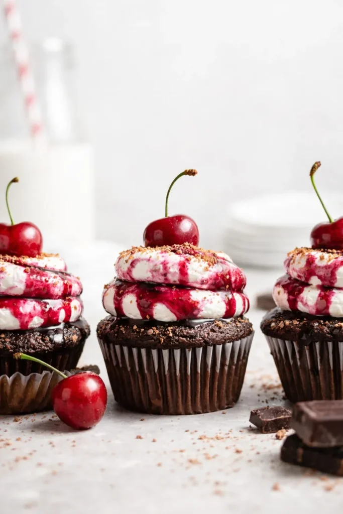 Black Forest Cupcakes with cherry topping and chocolate base close-up