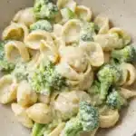 Creamy broccoli pasta with shell pasta and parmesan sauce in a ceramic bowl