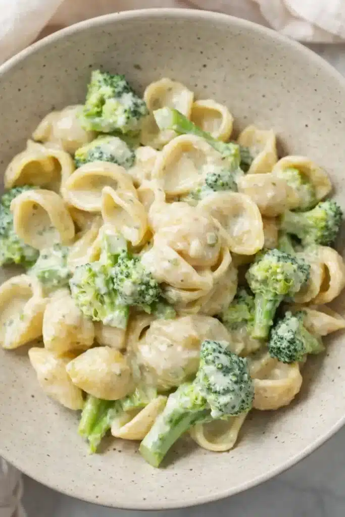 Creamy broccoli pasta with shell pasta and parmesan sauce in a ceramic bowl