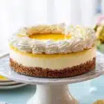 Lemon cheesecake with creamy filling and glossy topping on a cake stand