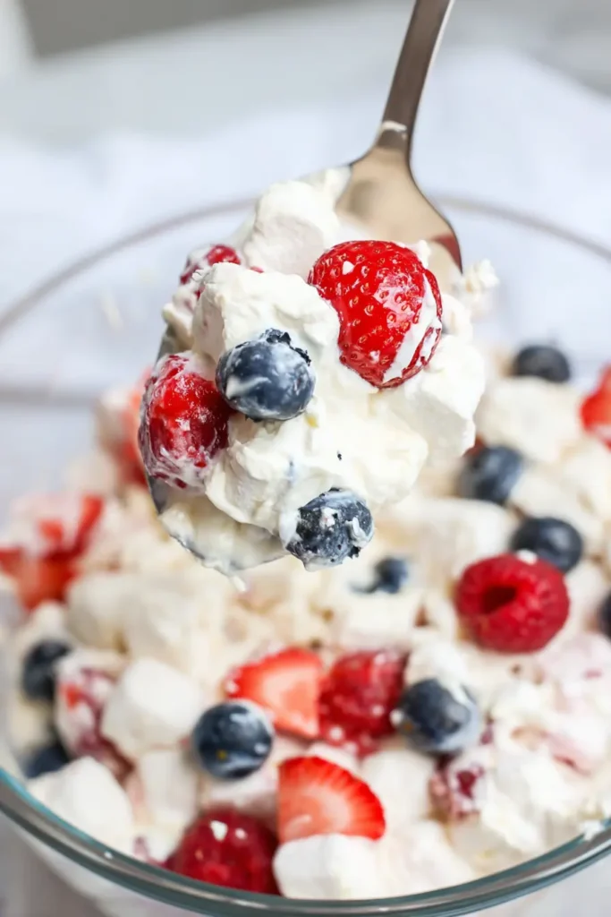 Red White and Blue Cheesecake Salad spoon with creamy texture and berries
