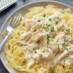 Crock Pot Angel Chicken served over angel hair pasta with creamy sauce