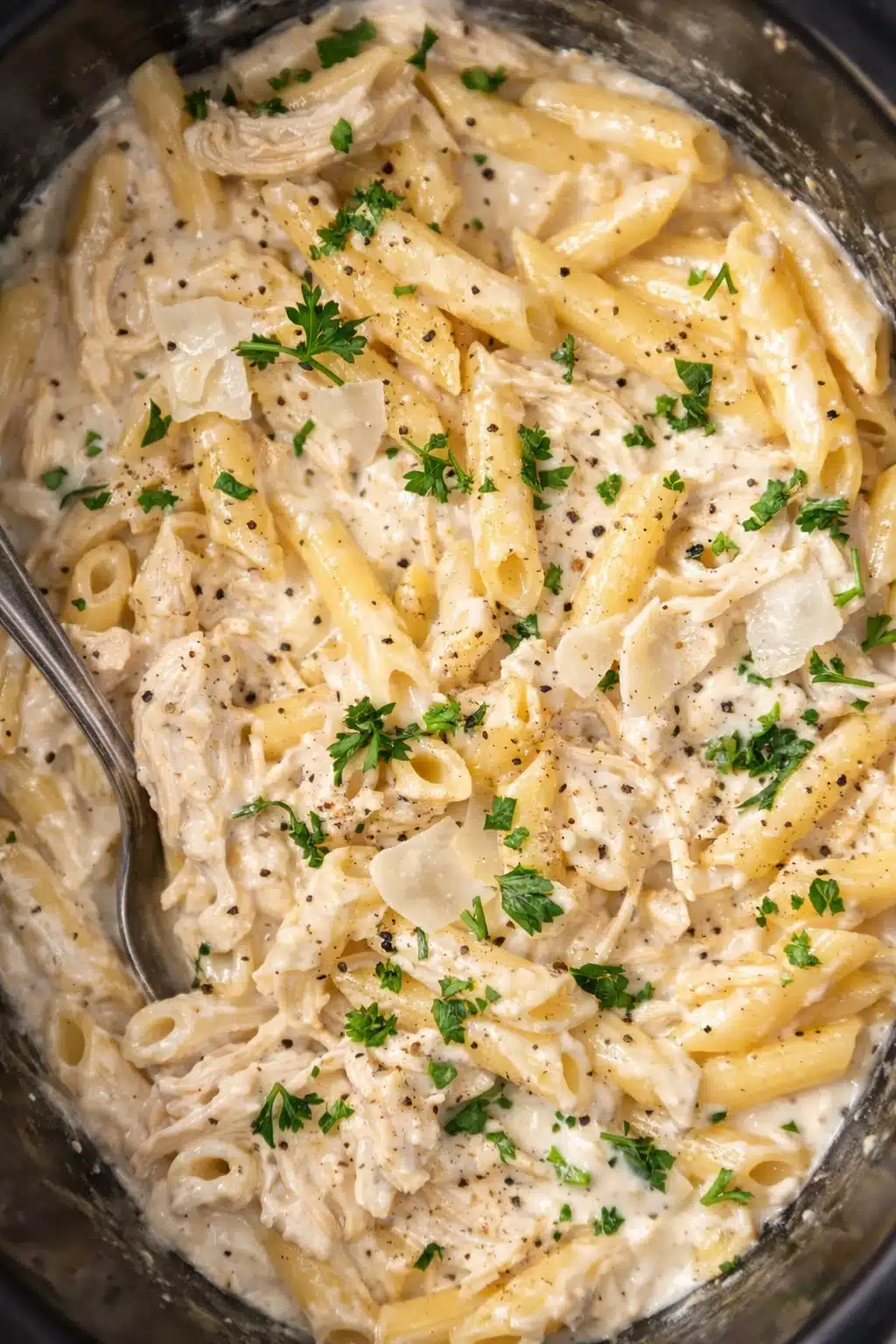 Crockpot Chicken Alfredo with penne pasta in creamy parmesan sauce