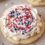 Crumbl patriotic birthday cake cookie with white frosting and red blue sprinkles