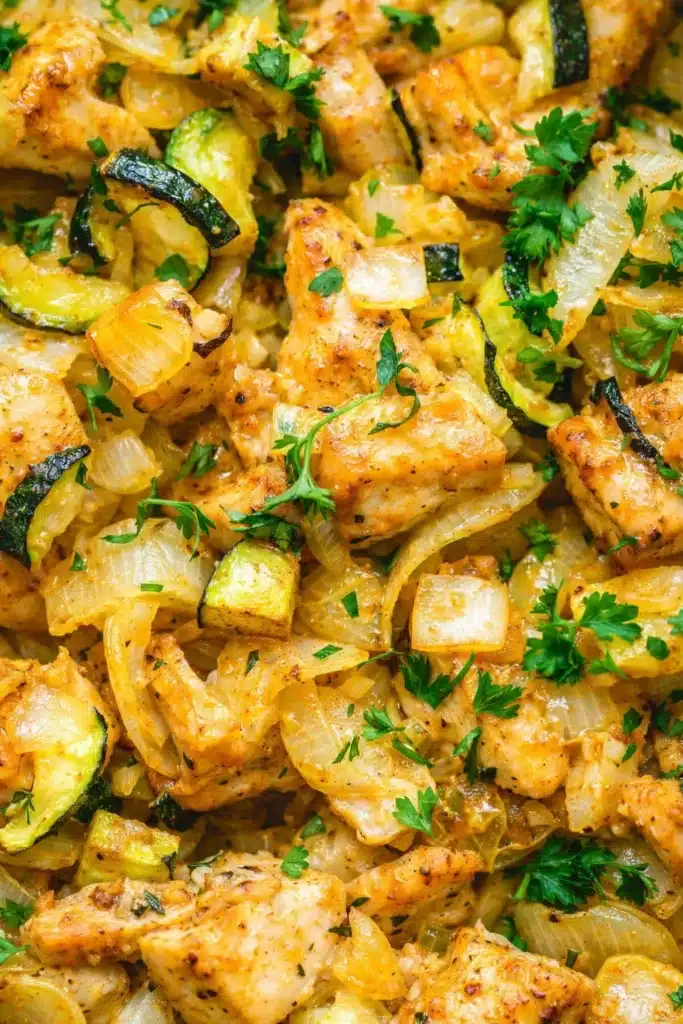 Easy baked chicken and zucchini close-up showing juicy texture