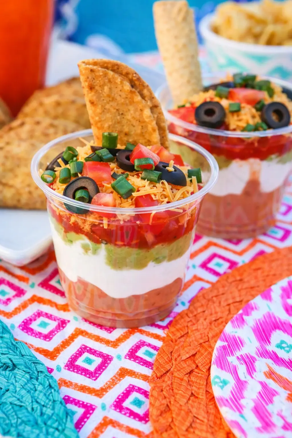 Easy Cinco de Mayo snacks with seven layer dip cups and tortilla chips