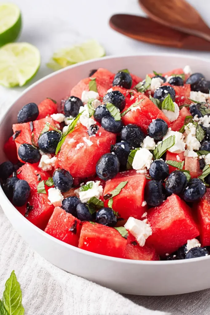 Watermelon Feta Salad with blueberries, mint, and lime in a bowl
