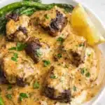 Garlic Butter Steak Bites with Creamy Parmesan Sauce 7 Garlic butter steak bites with creamy sauce over mashed potatoes and greens
