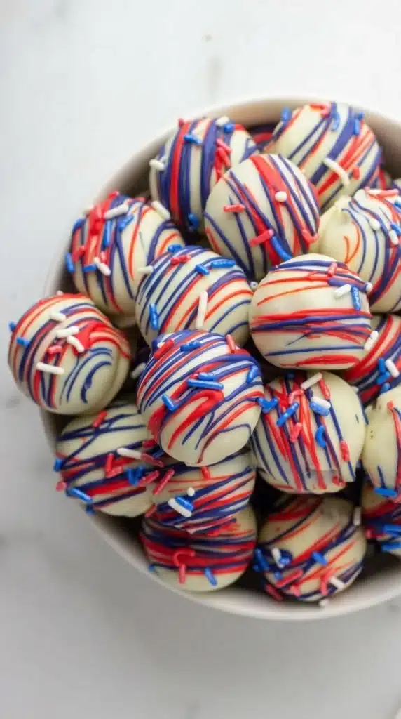 Patriotic Oreo Balls with white chocolate coating and red blue drizzle