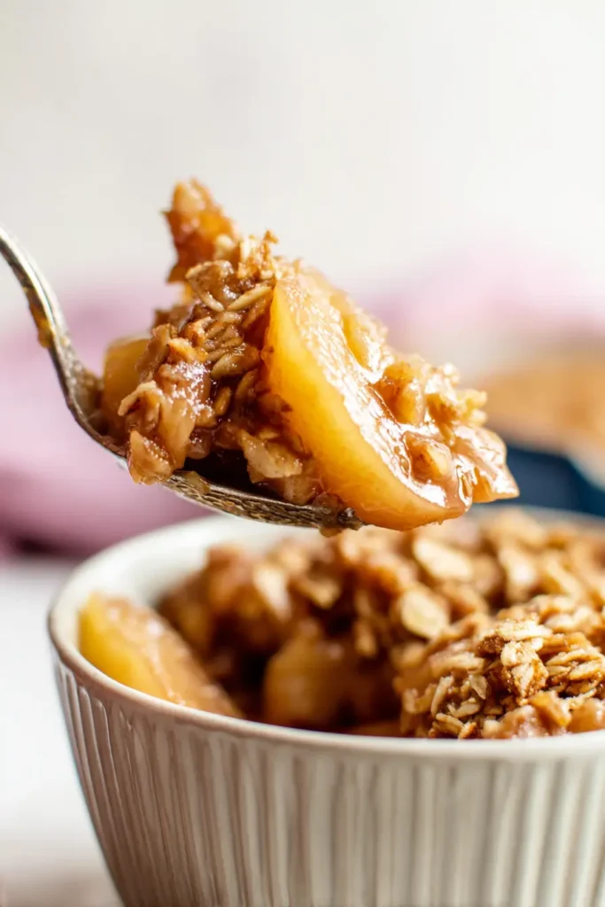 Peach Crisp spoonful with juicy peaches and crispy oat topping