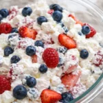 Red white and blue cheesecake salad with fresh berries in a creamy fluffy base