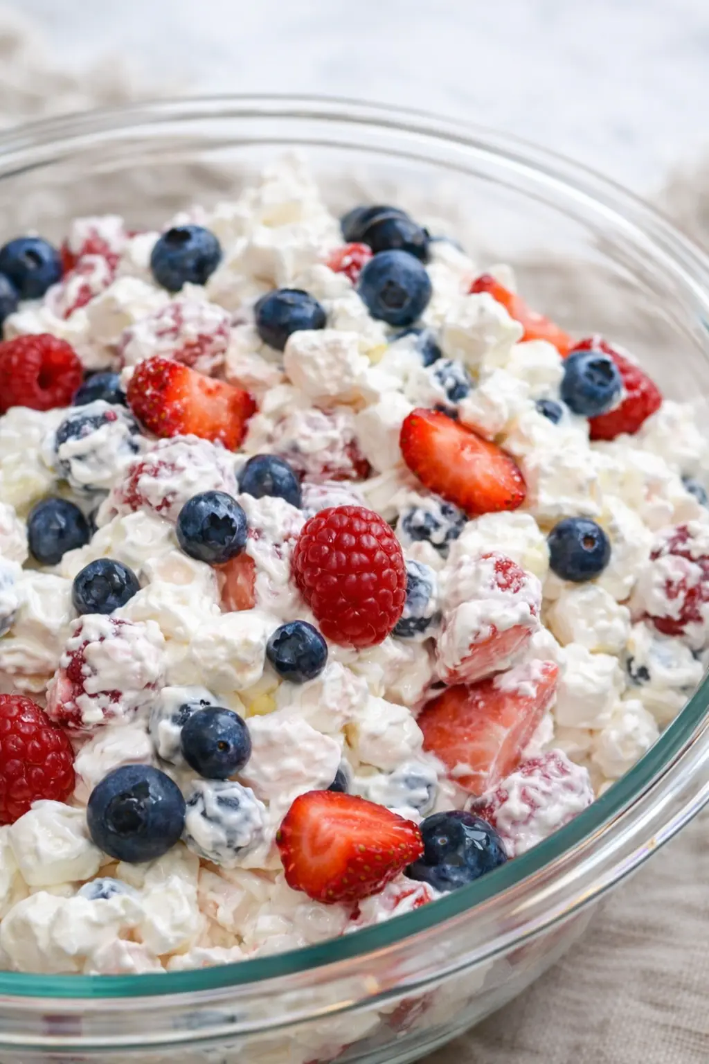 Red white and blue cheesecake salad with fresh berries in a creamy fluffy base