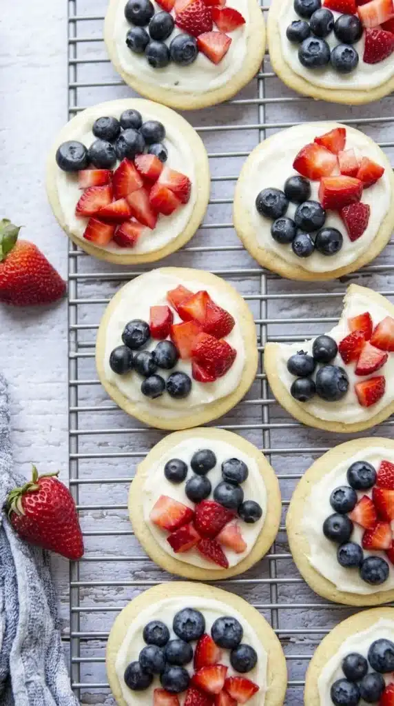 red white and blue mini fruit pizzas with strawberries and blueberries
