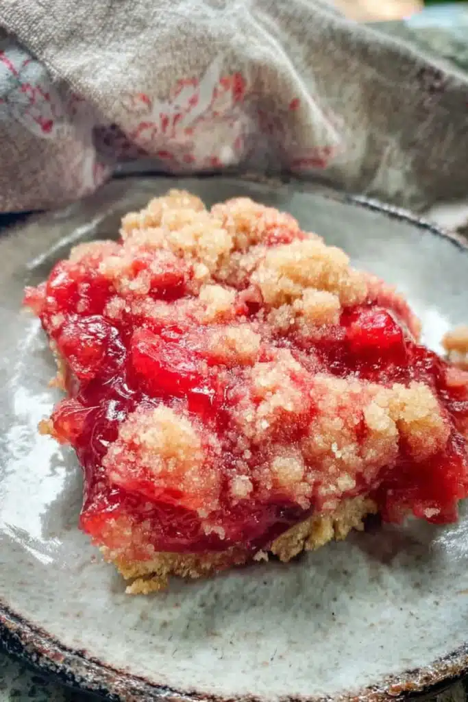 Rhubarb dessert recipe with jello showing gooey filling and crumb topping