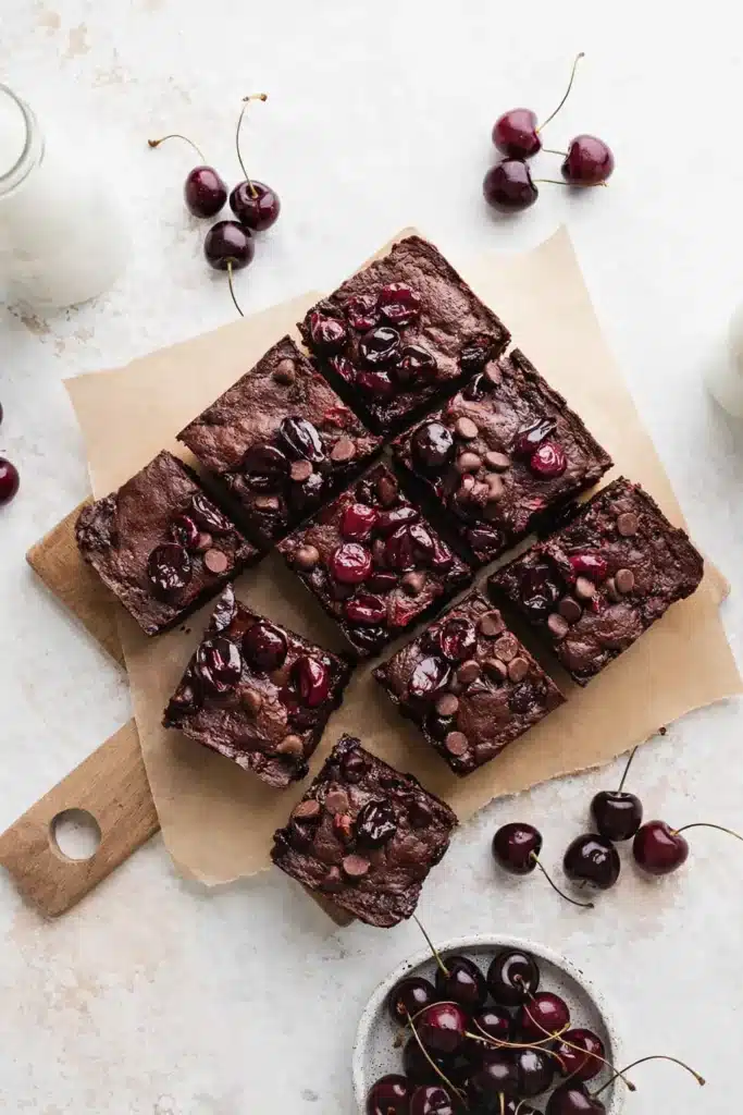Roasted Chocolate Cherry Brownies squares with glossy cherries on top